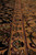 Gold main border and narrow guard stripes seen up close, dense low wool pile