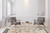 Living room with grey chairs and brass table over ivory 8x11 Moroccan diamond wool rug