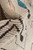 Folded corner showing apricot, teal and charcoal knots across the dense hand-knotted wool pile