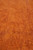 Rust orange wool pile detail revealing dense hand-knotted weave and warm terracotta color tones