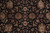 Close detail of black field with gold, burgundy and green palmettes, rosettes and leafy vines
