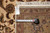Back tag marked 9 x 12 beside tape measure confirming size of hand-woven Oriental rug