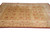 Angled floor view of transitional gold rug with ivory border and deep burgundy outer edge