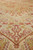 Ivory border meeting gold field, showing fine knotting and crisp burgundy outline drawing