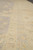 Border close-up showing layered guard stripes in gold, pale celadon and soft apricot tones