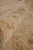 Rolled edge close-up revealing dense low wool pile, hand-knotted construction and soft vintage coloring