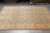 Blue grey field with gold florals on a large 9x12 Oriental rug, showroom floor