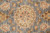Close-up of an ivory and peach rosette medallion woven on the soft slate field