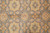 Detail of repeating gold and cream palmettes framed by leaf vines across grey ground