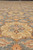 Wool pile texture and gold floral heads seen at a low raking angle