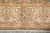 Beige main border with gold guard stripes, rust leaf forms and ivory cotton fringe