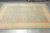 Angled gallery view showing the 9x12 Ziegler Oriental rug's wide gold and ivory border