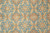 Field close-up of gold palmettes, salmon rosettes and ivory serrated leaves on blue ground