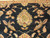 Detail of gold and sage crowned palmette resting on deep black ground with serrated leaves
