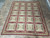 8 x 10 needlepoint flat weave rug shown on stone tile floor in showroom
