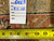 Back tag and tape measure on the 8' x 10' Serapi rug, inventory number 6463