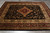 8' x 10'1" Jaipur rug laid on grey floor, black field, burgundy border, gold center medallion