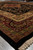 8x10 black Oriental rug corner seen low and close, deep pile and multi-band floral borders