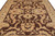 Close field view of hand-spun wool pile showing beige lotus palmettes and serrated brown leaves