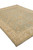 Corner perspective of green and beige hand-knotted wool rug with fringe and wide ivory border