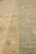 Macro view of pile texture where the ivory guard stripe meets the sage green open field