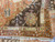 8'1" x 10' wool Agra rug folded back to show dense hand-knotted pile and cotton fringe