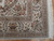 Corner detail showing multiple floral borders, zigzag guard stripes and clean ivory cotton fringe