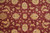 Detail of organic hand-spun wool pile showing abrash in burgundy field and ivory blossoms