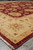 8x10 Afghan Chobi rug viewed from the corner on grey concrete showroom floor
