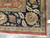Black ground border detail packed with sage, gold and brick red leaf motifs