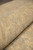 Close-up of the rug back rolled over itself, revealing uniform knot rows and hand-spun wool