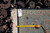 Back tag and tape measure on the reverse confirming hand-knotted construction and 8x10 rug size
