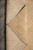 Folded corner revealing the cotton foundation and even hand-knotted rows on the back