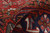 Folded pile showing dense wool depth, soft handle and saturated red tones of this vintage rug