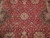 Close-up of lobed ivory medallion, pink rosettes and sage vines on burgundy field