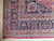 Corner detail of navy main border, salmon rosette minor borders and clean border turn resolution