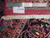 Back of rug with ruler, authentic handmade label, cotton foundation knots and ivory fringe