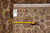 Back of rug with tape measure and dealer tag confirming 7'7" x 10' size
