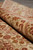 Rolled edge showing dense wool pile, ivory border scrollwork and brick red outlines