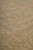 Close angled view of muted green vines and gold field highlighting hand-spun wool abrash variation