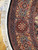 Border detail showing burgundy cartouche panels, blue guard stripes and black edge with cotton fringe