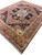 8' x 10' rust Serapi rug photographed at an angle with olive rosette border and fringe