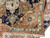 Back and front comparison of hand-knotted wool rug with cotton fringe and rust border