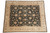 Hand-knotted Ziegler design rug photographed flat, dark field with tan rosettes and cream wide border