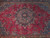 Close-up of 8 petal rosette medallion with pink palmettes and teal tracery on crimson ground