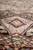 Macro close-up of salmon pink panel with rosette showing silk highlights and dense hand-knotted pile