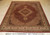 8'2" x 10'2" hand-knotted Oriental rug showing diamond medallion, fish pattern field and scrolling ivory border