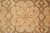 Macro of 8 petal rosette medallion in gold and sage on warm brown ground