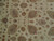 Close up of ivory field showing palmettes, rosettes and delicate vine work in soft golds