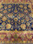 Royal blue field filled with gold palmettes, rosettes and curling vines above burgundy border